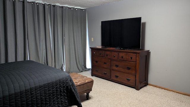 carpeted bedroom featuring a textured ceiling