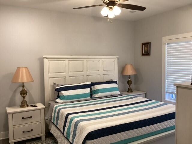 bedroom with multiple windows and ceiling fan