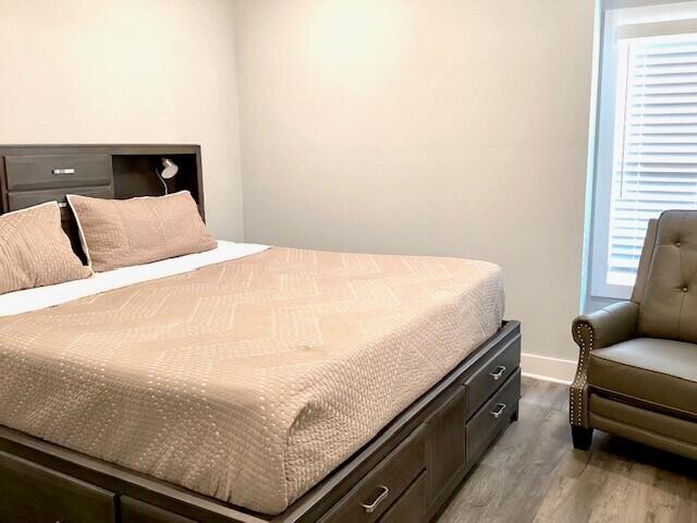 bedroom featuring light hardwood / wood-style flooring and multiple windows