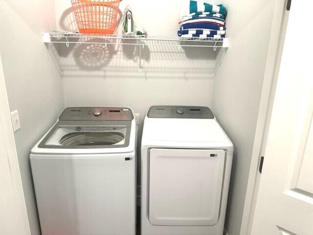 clothes washing area featuring washer and dryer