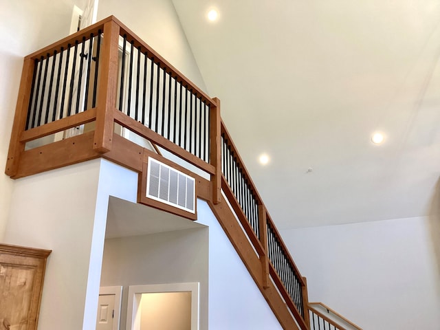 stairway with high vaulted ceiling