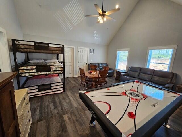 game room featuring high vaulted ceiling, ceiling fan, and dark hardwood / wood-style flooring