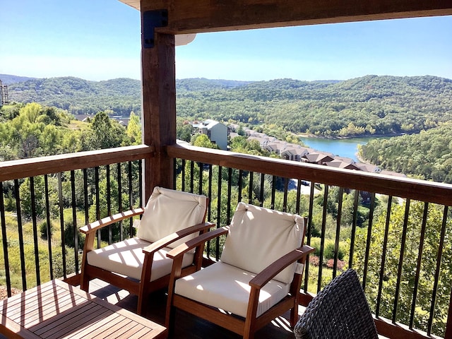 deck with a water and mountain view