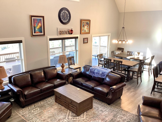 living room featuring a notable chandelier, plenty of natural light, and hardwood / wood-style floors