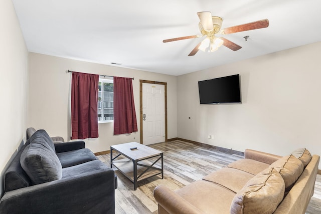 living room with ceiling fan and light hardwood / wood-style floors