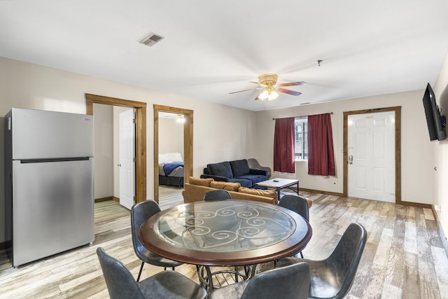 dining area with ceiling fan and light hardwood / wood-style floors