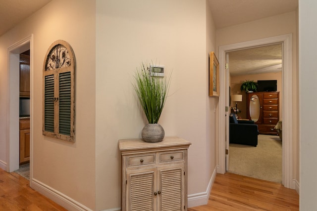 hallway with light hardwood / wood-style flooring