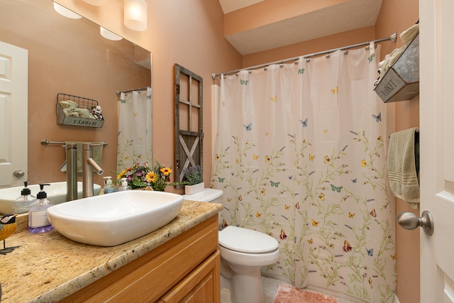 bathroom with vanity, walk in shower, and toilet