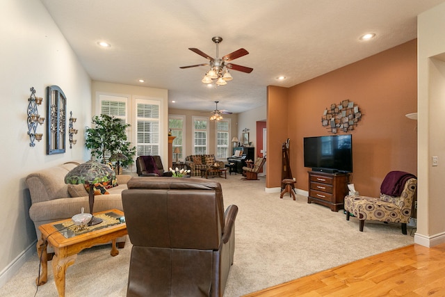 living room with light hardwood / wood-style floors and ceiling fan