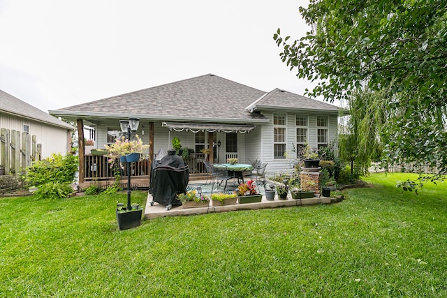 back of house featuring a lawn and a patio area