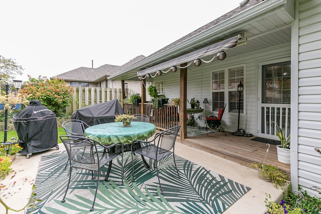 view of patio / terrace with a wooden deck and a grill