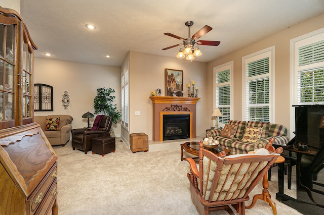 living room featuring light carpet and ceiling fan