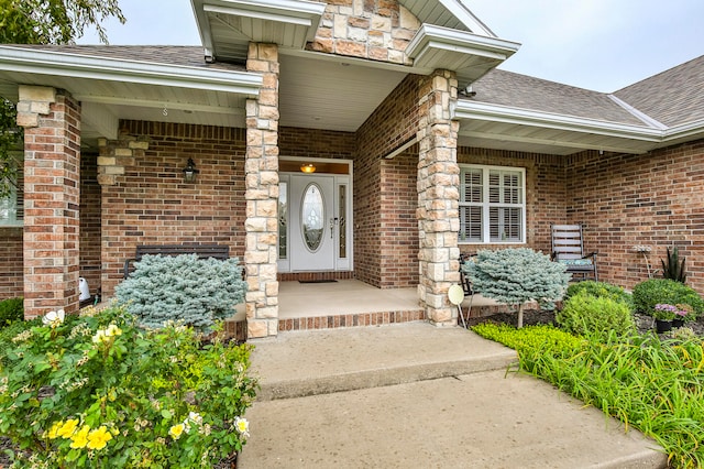 view of exterior entry with a porch