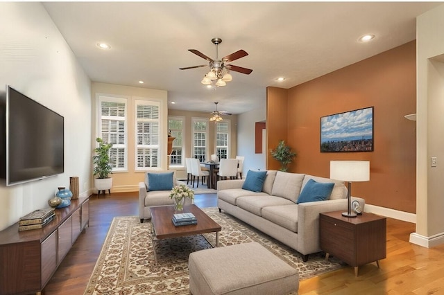 living room featuring hardwood / wood-style flooring and ceiling fan