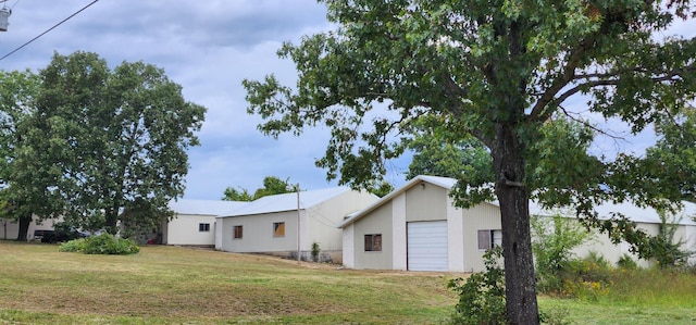 view of home's exterior with a yard and a garage