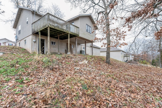 rear view of property with a wooden deck