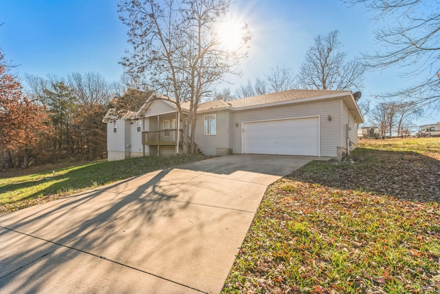 ranch-style house featuring a garage and a front yard