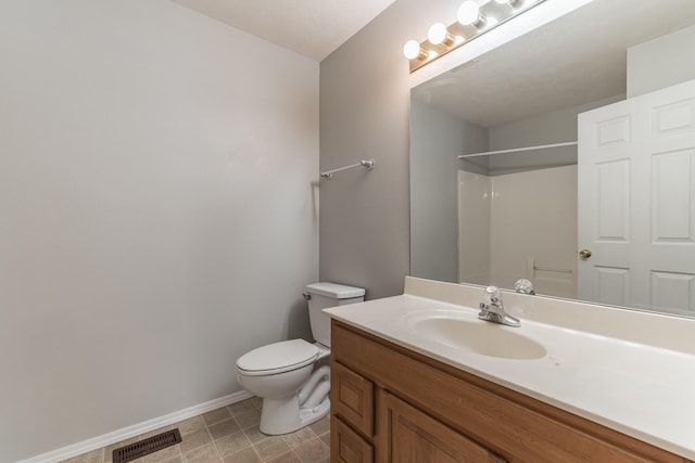 bathroom featuring vanity, a shower, and toilet