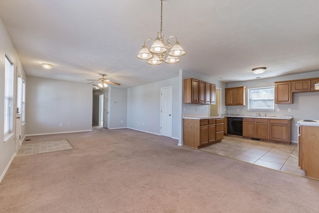 kitchen with ceiling fan with notable chandelier, light carpet, sink, dishwasher, and hanging light fixtures