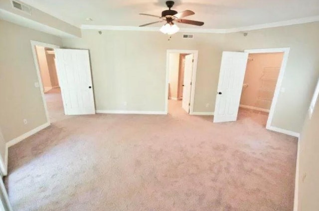 unfurnished bedroom with baseboards, crown molding, and visible vents