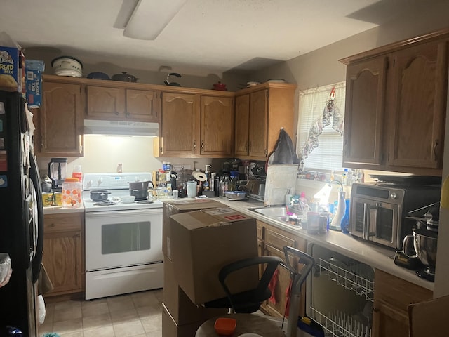 kitchen with light tile patterned flooring, black fridge, electric stove, and sink