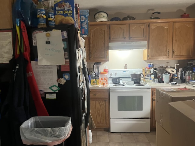 kitchen with light tile patterned floors, black fridge, and white electric stove