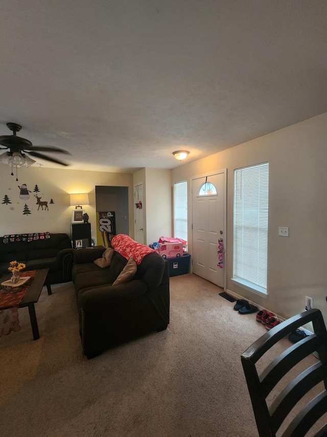 living room featuring ceiling fan and carpet floors