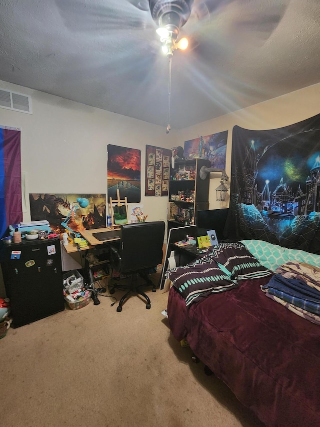 bedroom with carpet flooring, a textured ceiling, and ceiling fan