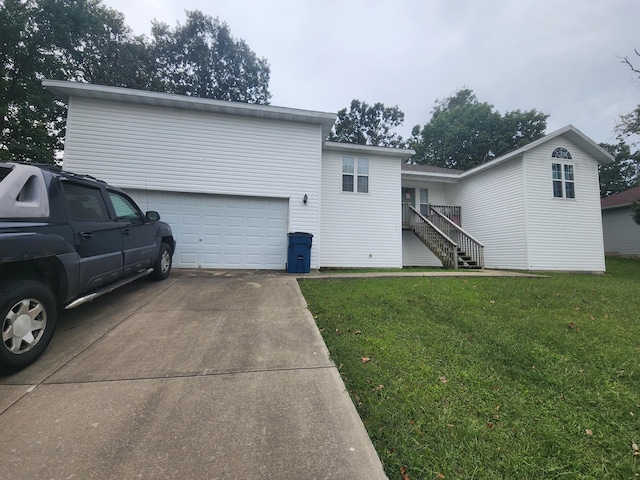 rear view of house with a garage and a yard