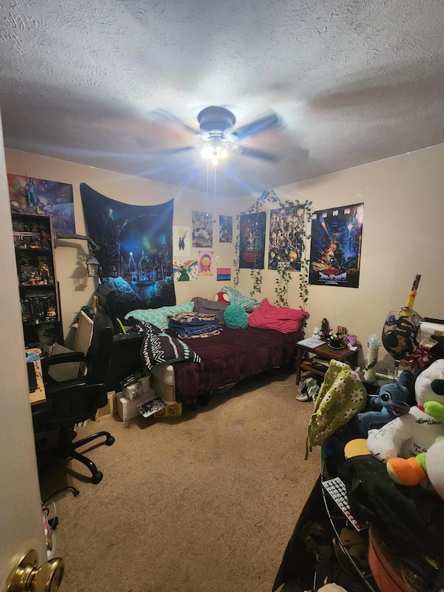 carpeted bedroom featuring ceiling fan and a textured ceiling