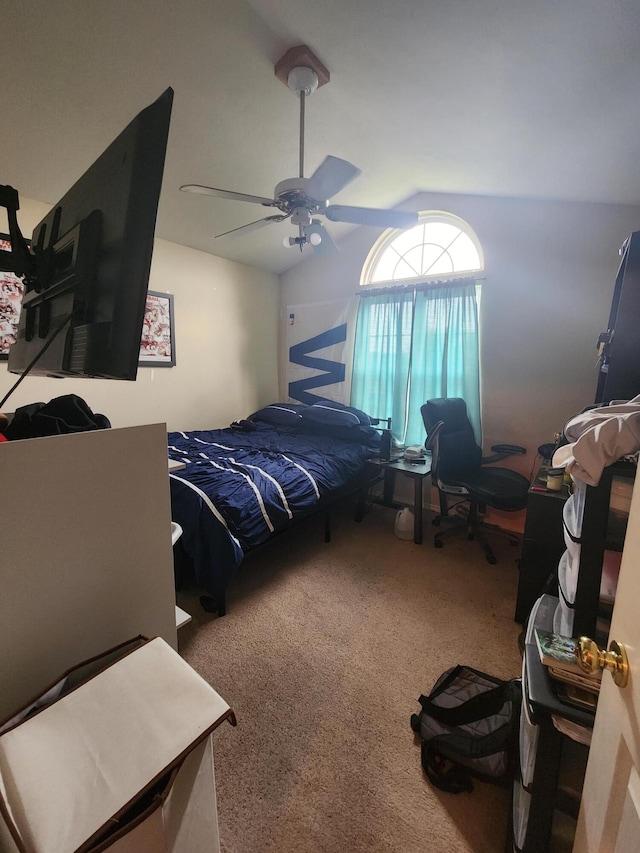 bedroom featuring ceiling fan, vaulted ceiling, and carpet