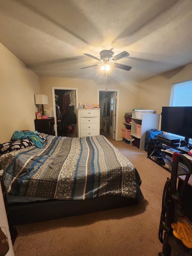 bedroom with ceiling fan, a textured ceiling, a closet, and carpet