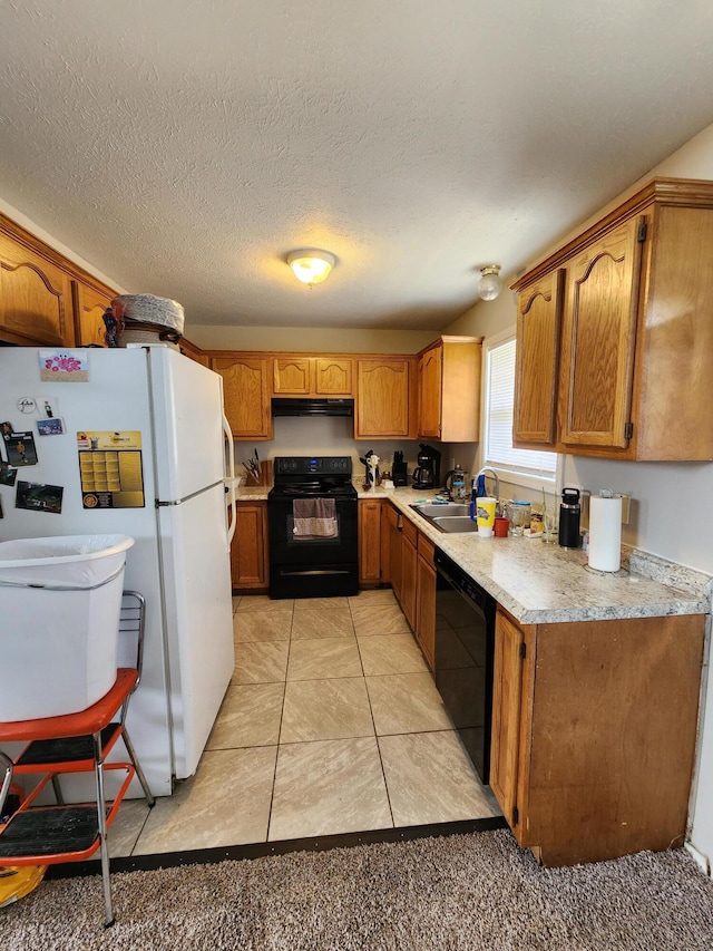 kitchen featuring black appliances, ventilation hood, sink, light tile patterned floors, and a textured ceiling