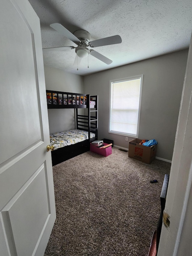 1213 Woodland, Monett, MO 65708 - carpeted bedroom featuring a textured ceiling, baseboards, and ceiling fan