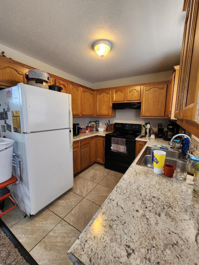 kitchen featuring black / electric stove, white refrigerator, sink, and a textured ceiling