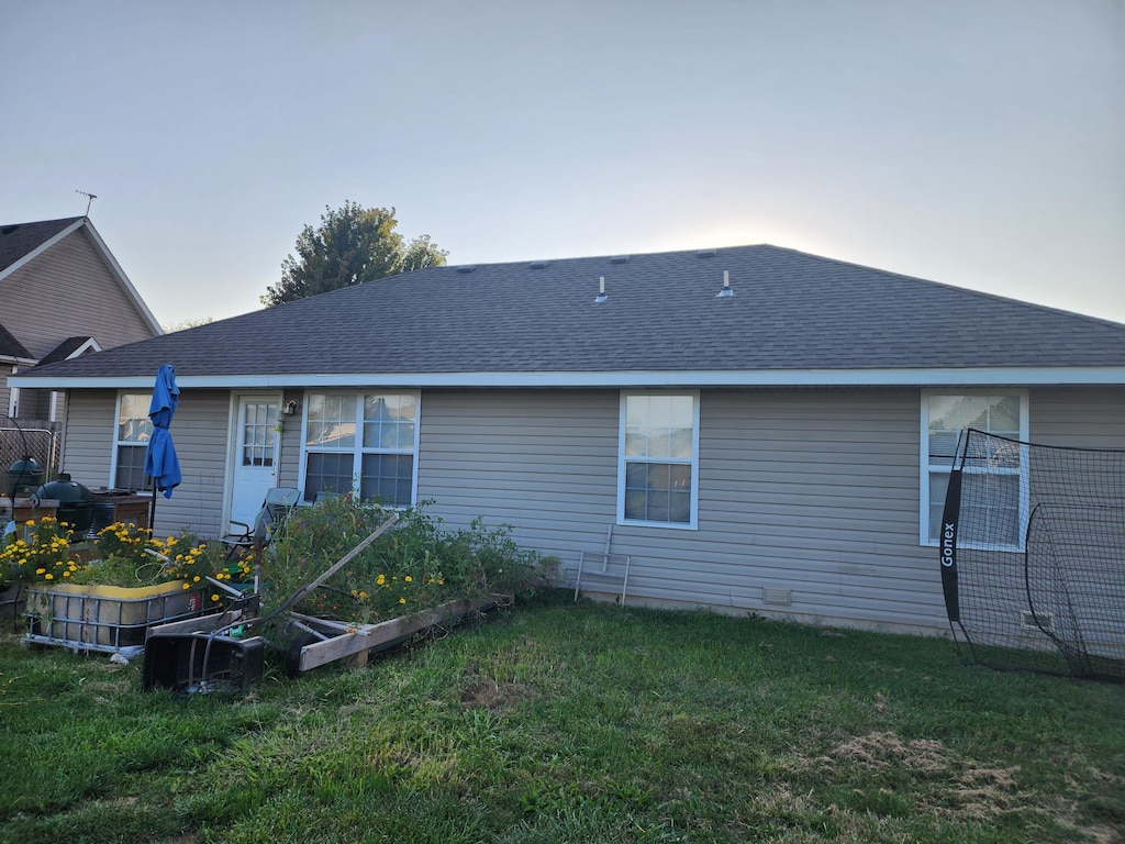 back of house with a yard