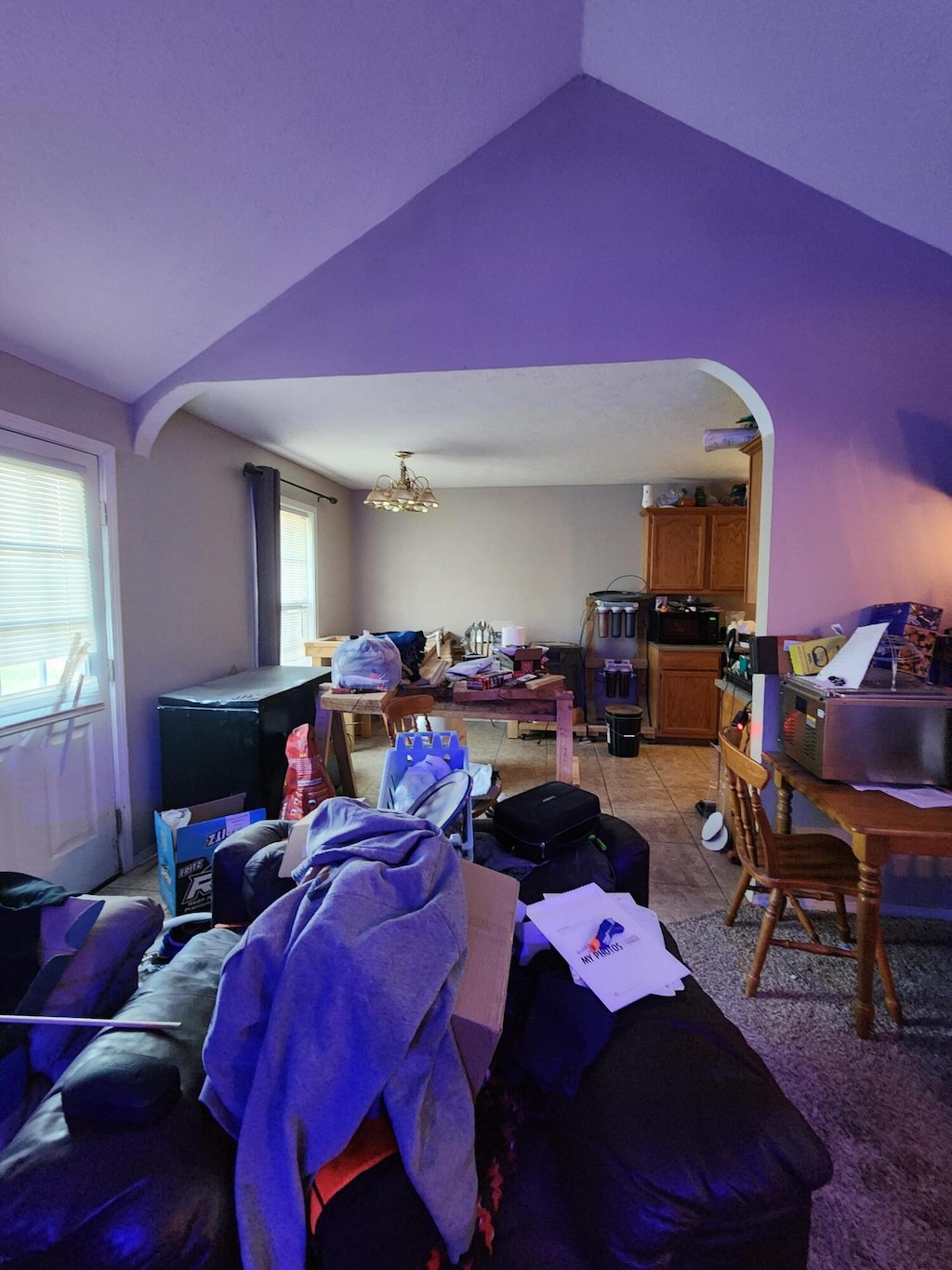 living room with lofted ceiling and light tile patterned flooring