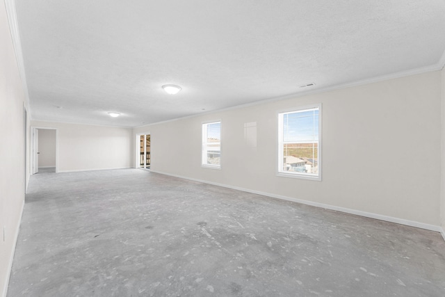 spare room with crown molding and a textured ceiling