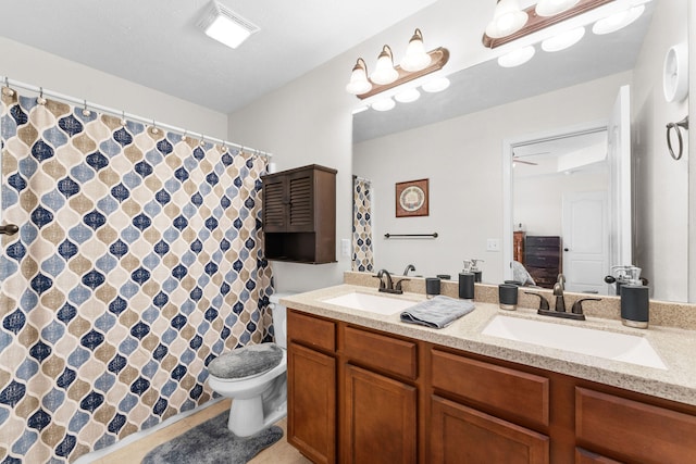 bathroom featuring ceiling fan, a shower with curtain, vanity, and toilet