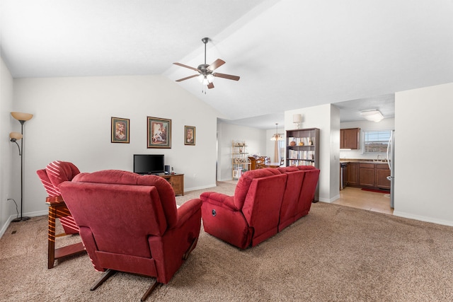 living room featuring ceiling fan, vaulted ceiling, and light carpet