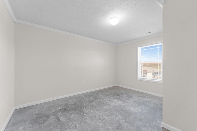 spare room with ornamental molding, concrete flooring, and a textured ceiling