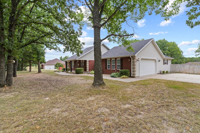 ranch-style house featuring a front yard and a garage