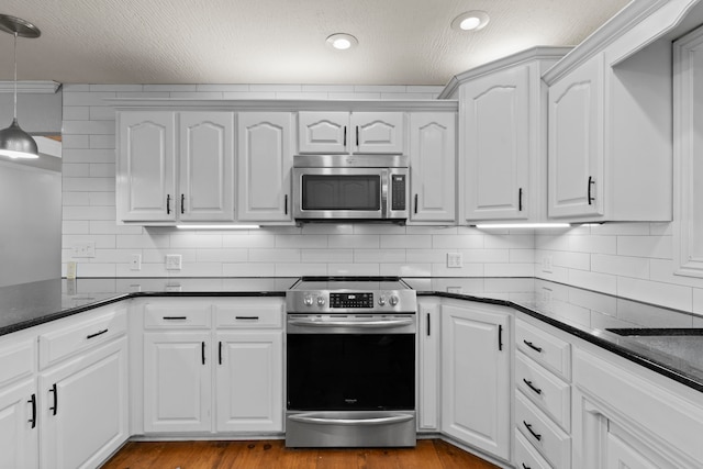 kitchen with appliances with stainless steel finishes and white cabinets