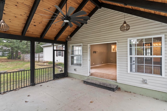 unfurnished sunroom featuring lofted ceiling with beams, ceiling fan, and wood ceiling