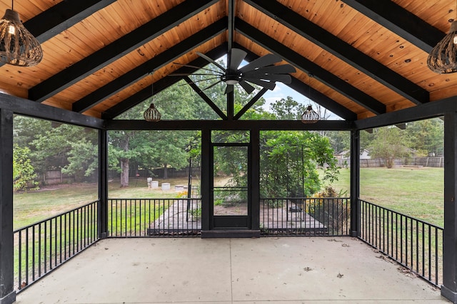 unfurnished sunroom with lofted ceiling with beams, ceiling fan, and wooden ceiling