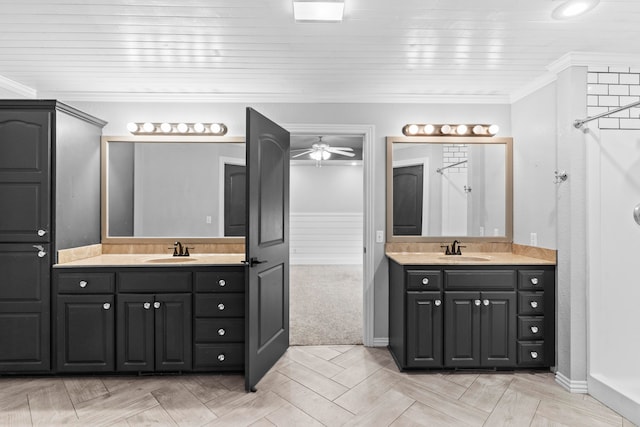 bathroom featuring ornamental molding, vanity, and ceiling fan