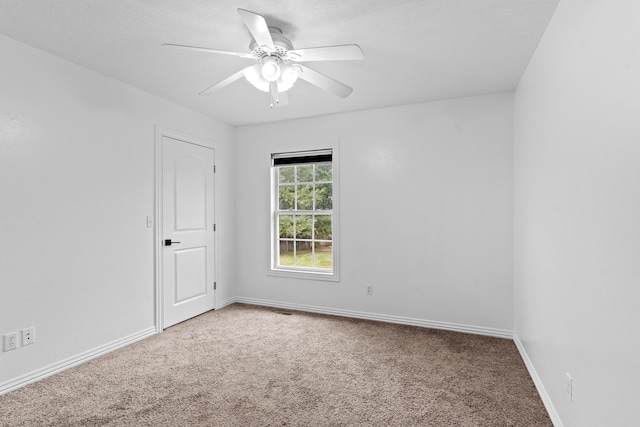 empty room featuring carpet floors and ceiling fan