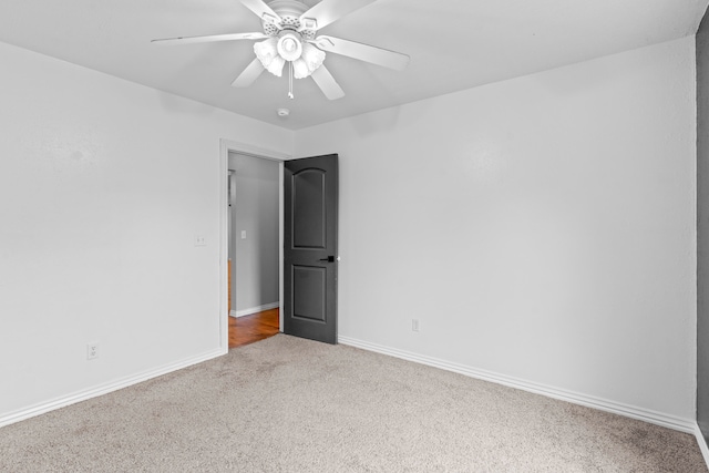 empty room featuring ceiling fan and carpet flooring