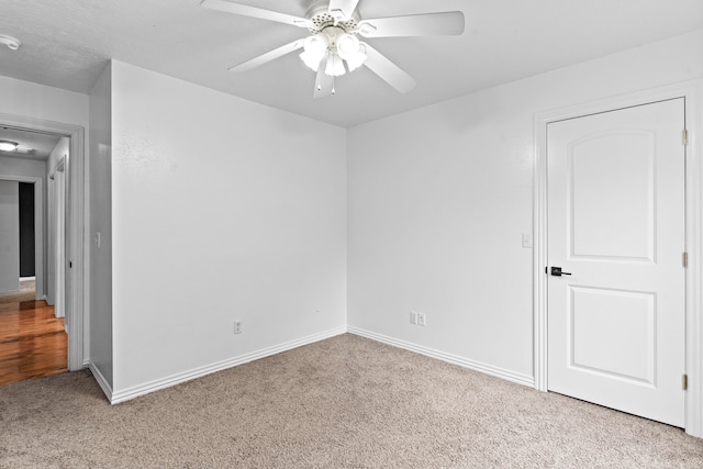 empty room with light carpet and ceiling fan