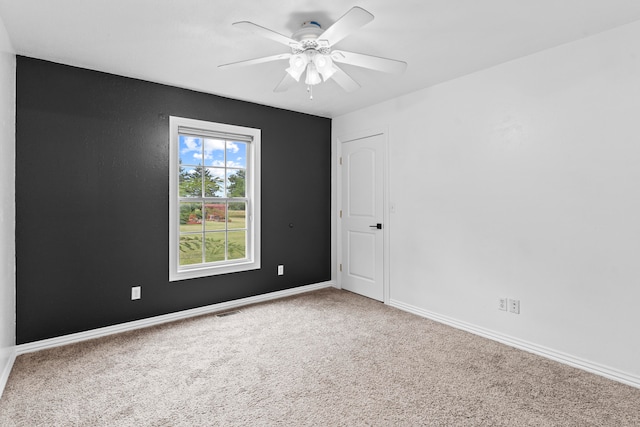 carpeted empty room featuring ceiling fan